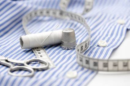 Laundered shirt with thread, thimble, measuring tape and shears