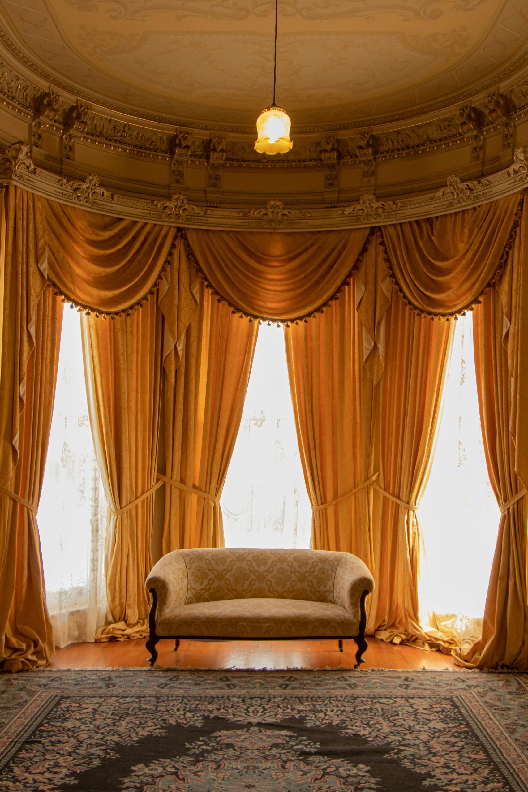 elaborate gold drapes hung in windows