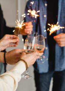 people holding sparklers and champagne